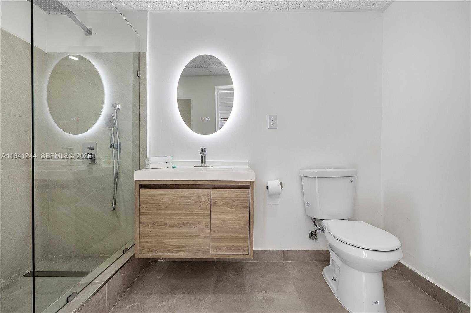 10361 Southwest 119th Street Miami, FL 33176 - Photo 34 of 38 a bathroom with a toilet sink and a mirror