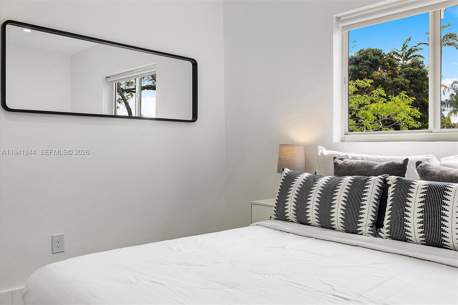 10361 Southwest 119th Street Miami, FL 33176 - Photo 37 of 38 a bedroom with a bed and a painting on the wall