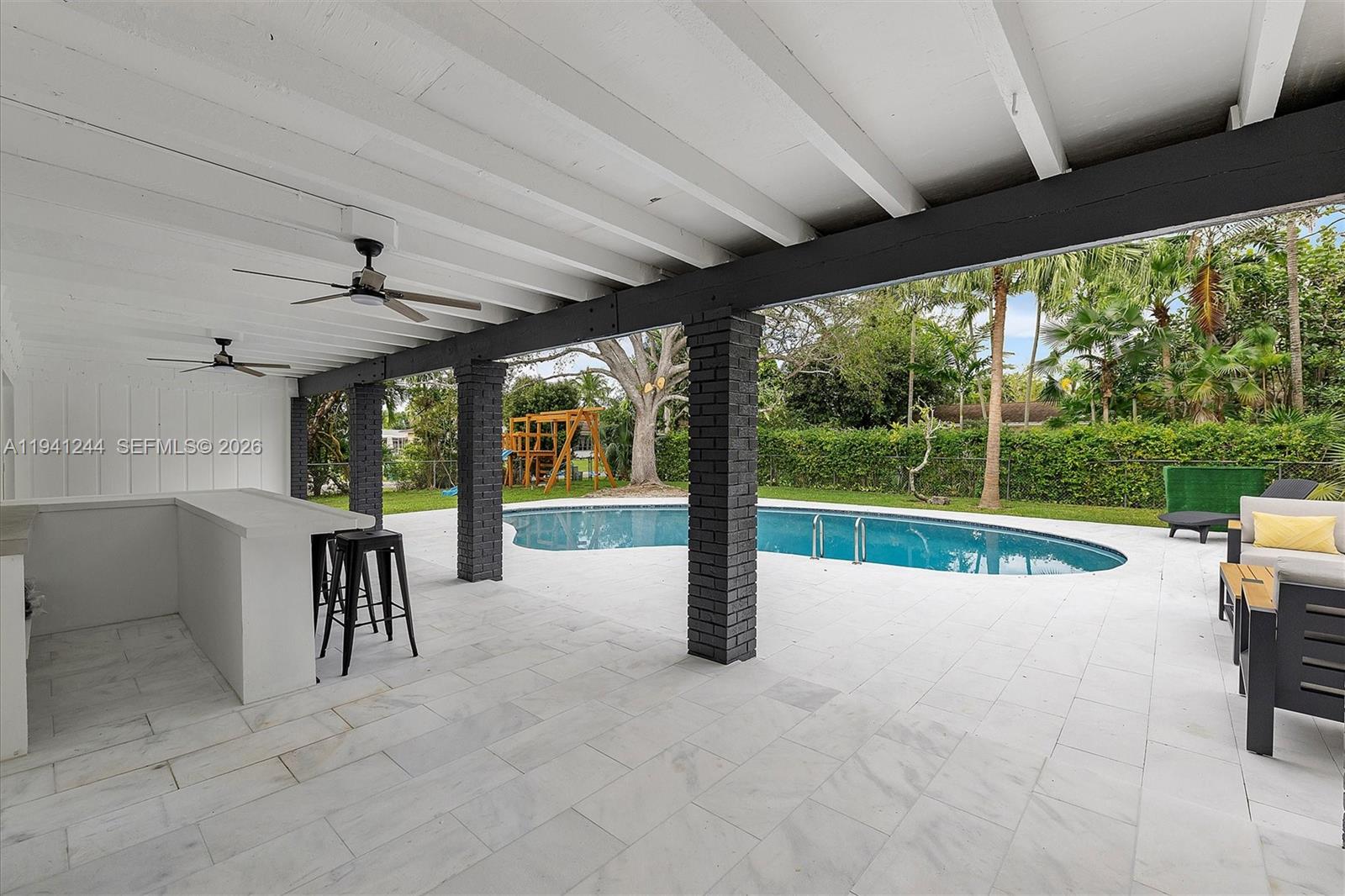 10361 Southwest 119th Street Miami, FL 33176 - Photo 6 of 38 a view of a patio with a backyard