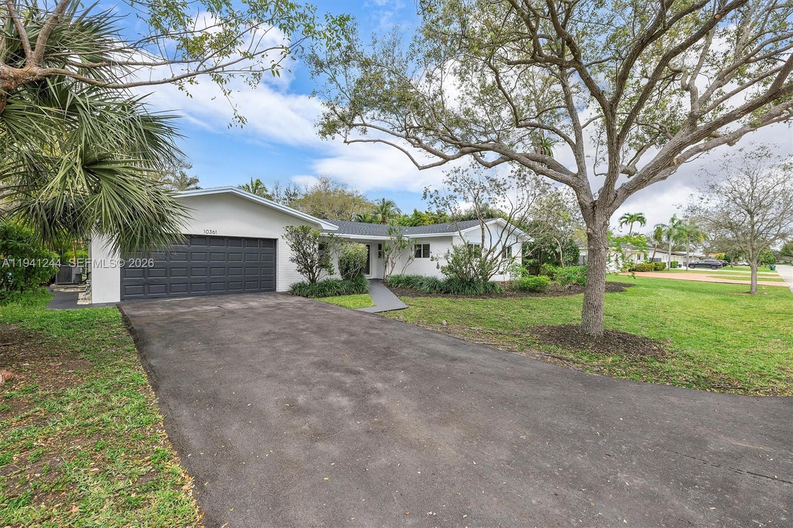 10361 Southwest 119th Street Miami, FL 33176 - Photo 10 of 38 a view of a house with backyard and trees