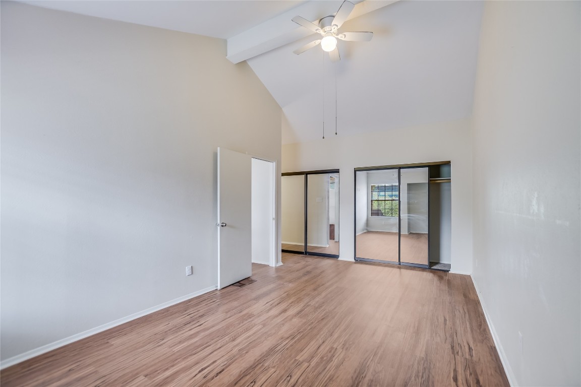 1748 Ohlen Road, Unit 36 Austin, TX 78757 - Photo 15 of 21 an empty room with wooden floor fan and windows