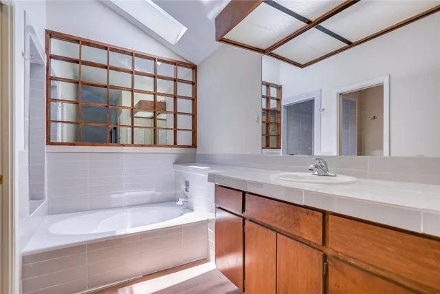 a bathroom with a bathtub and a sink