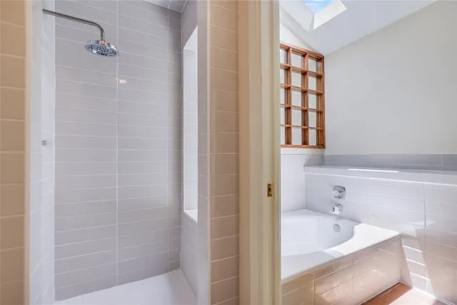 a bathroom with a tub and a shower