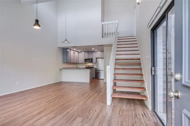 a view of a kitchen with wooden floor and electronic appliances