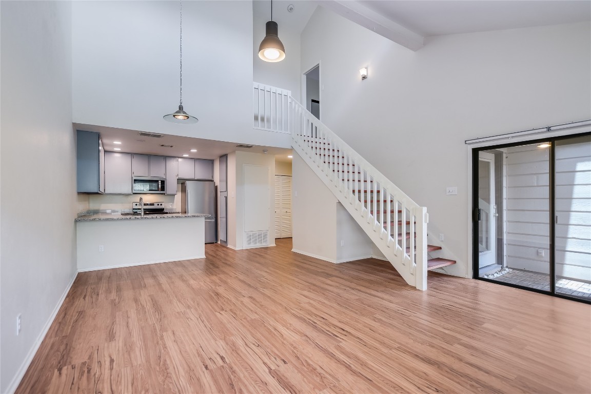 1748 Ohlen Road, Unit 36 Austin, TX 78757 - Photo 5 of 21 a view of kitchen and hallway with wooden floor