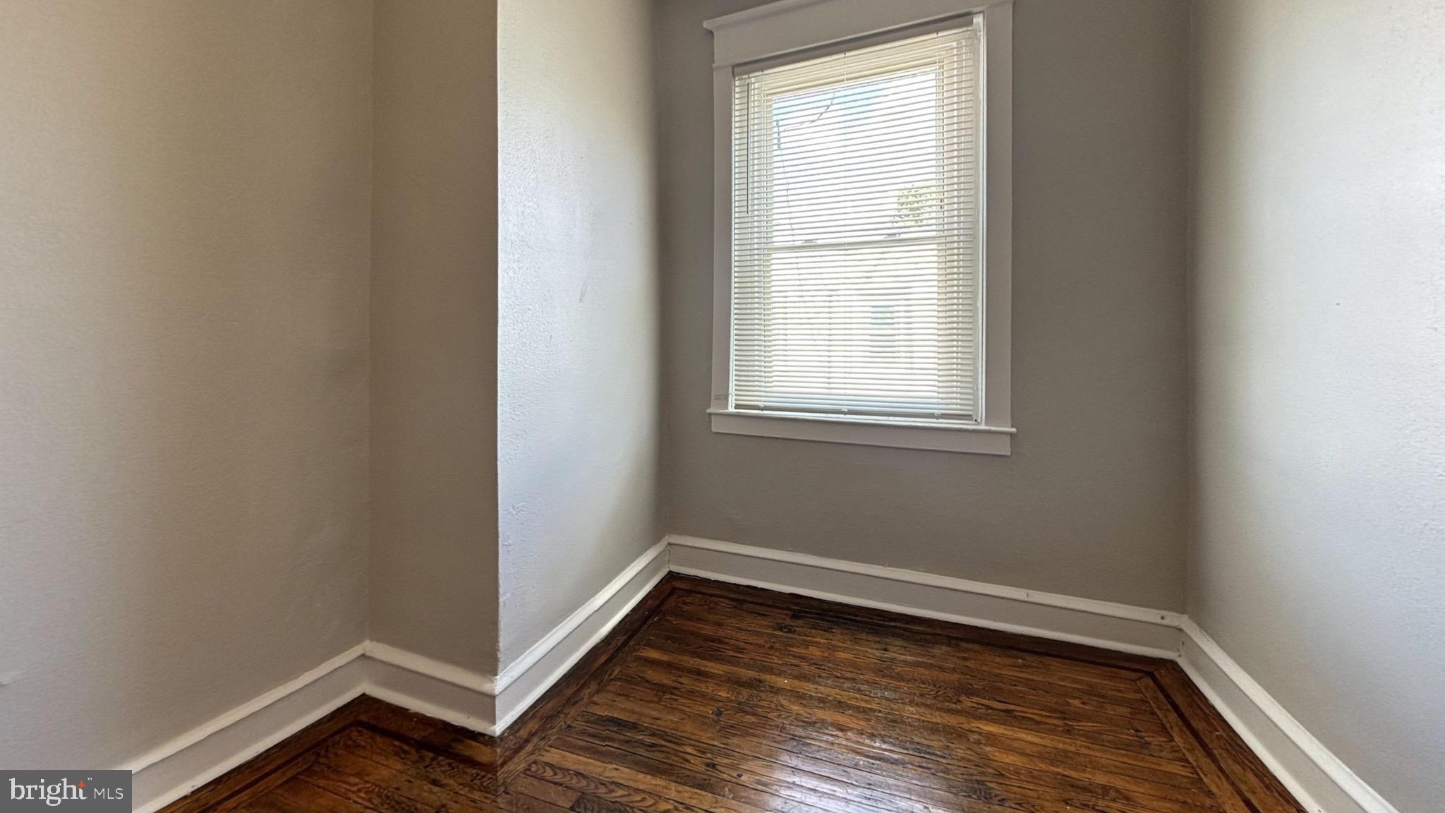 5581 Blakemore Street Philadelphia, PA 19138 - Photo 5 of 14 a view of an empty room with wooden floor and a window