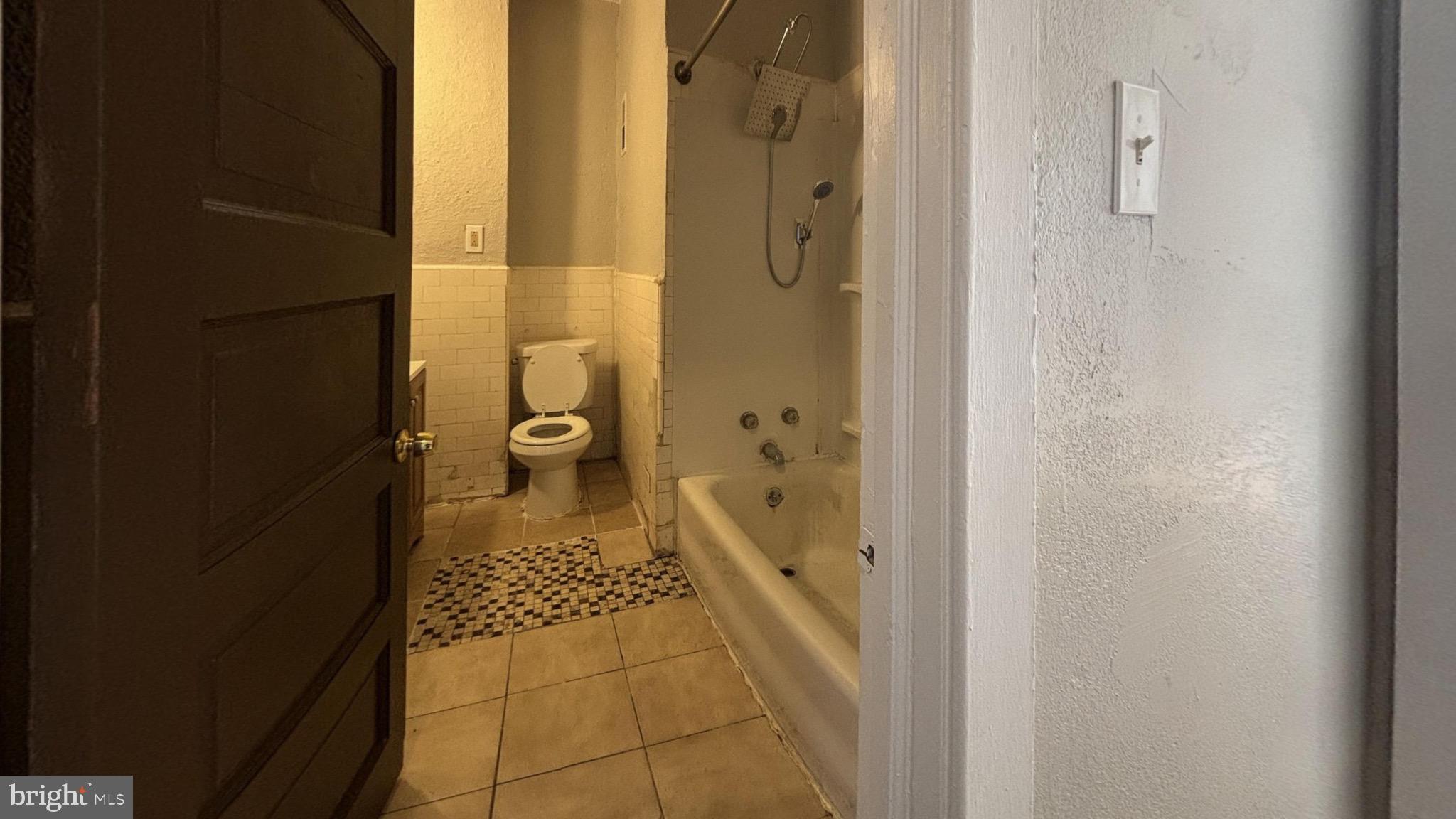 5581 Blakemore Street Philadelphia, PA 19138 - Photo 8 of 14 a bathroom with a glass door shower