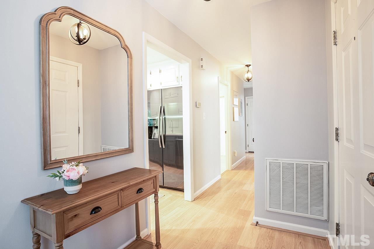 8105 Brumbley Place Raleigh, NC 27612 - Photo 3 of 23 a bathroom with a sink mirror and vanity