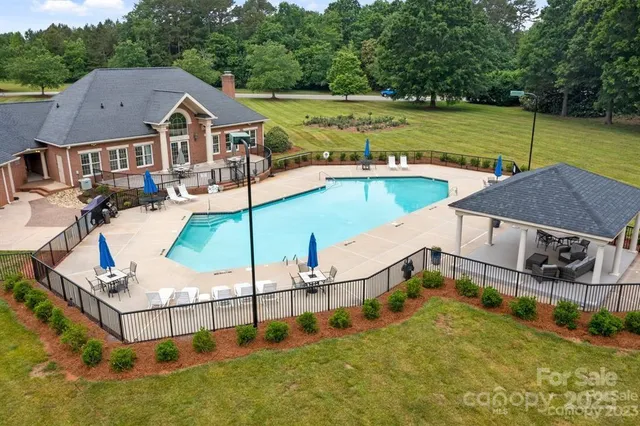 an aerial view of a house having swimming pool garden and patio