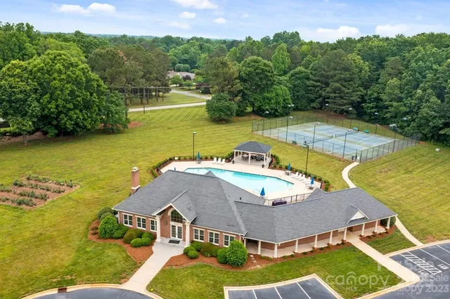 an aerial view of a house with a swimming pool