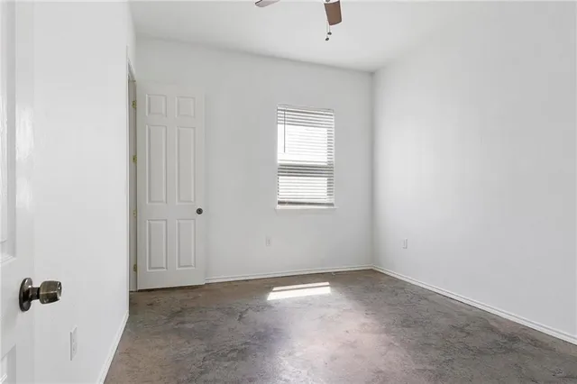 an empty room with a empty space and windows