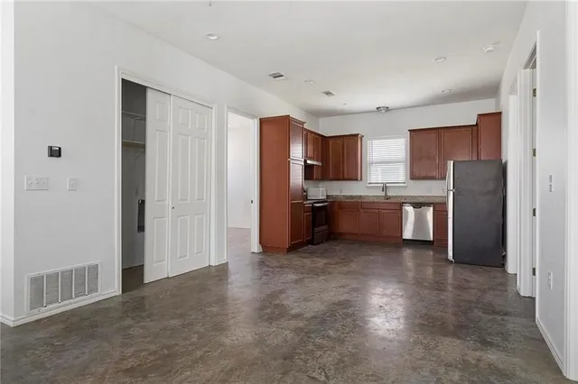 an empty room with fan and windows