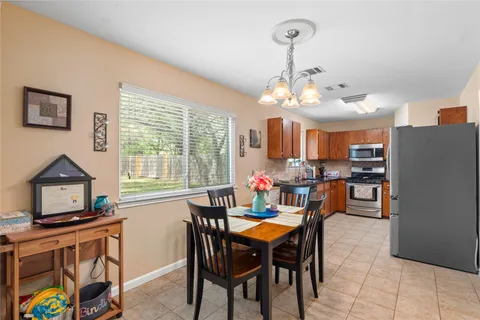 a dining room with furniture and window