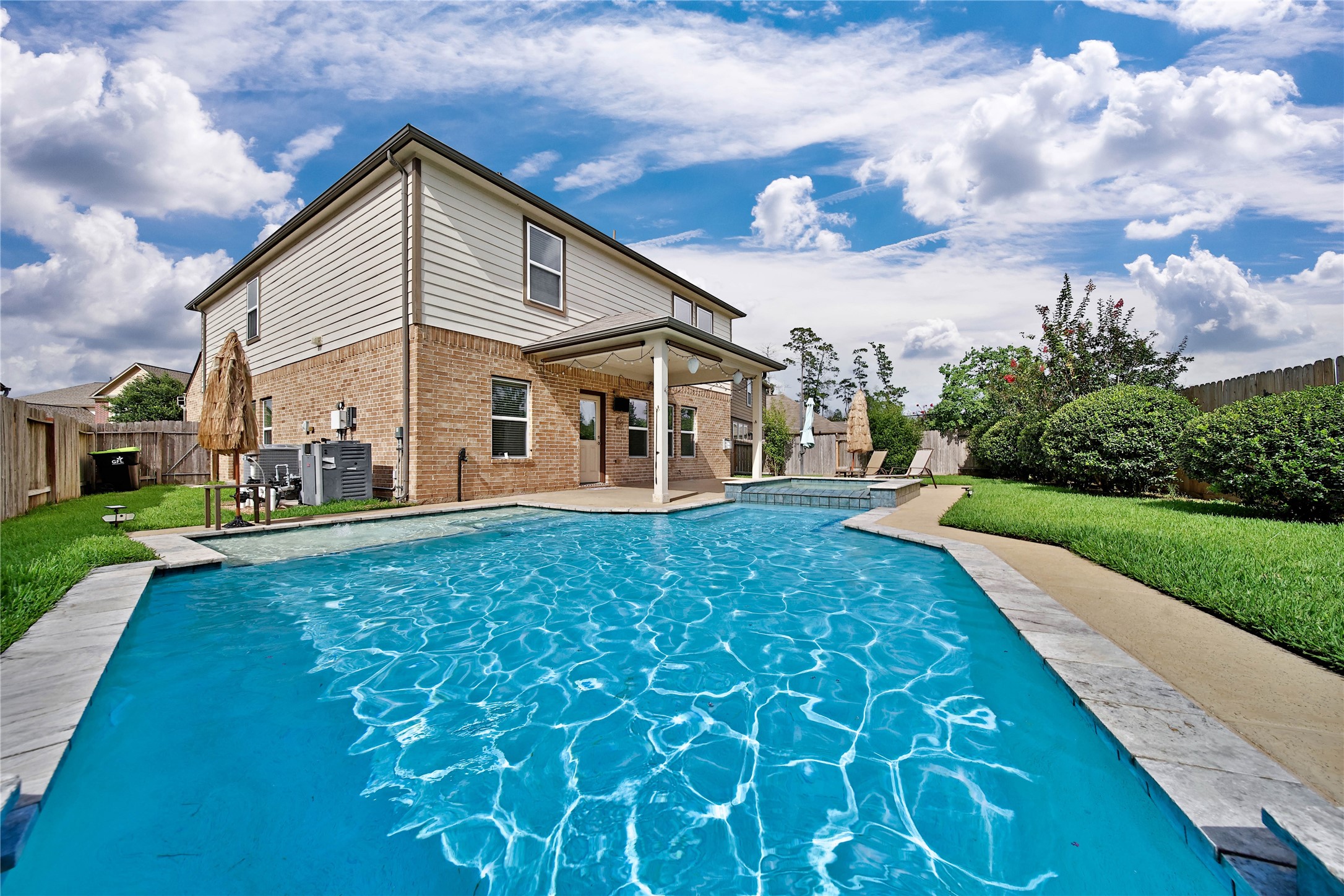 2672 Magnolia Fair Way Spring, TX 77386 - Photo 29 of 49 There are built-in umbrella holder in your pool deck at the sun shelf and hot tub for a little shade by the pool. A door from the garage to your side yard is convenient for pool toys storage. And there's a sidewalk from your driveway to this garage door. It's the little extra things that truly make a home special.
