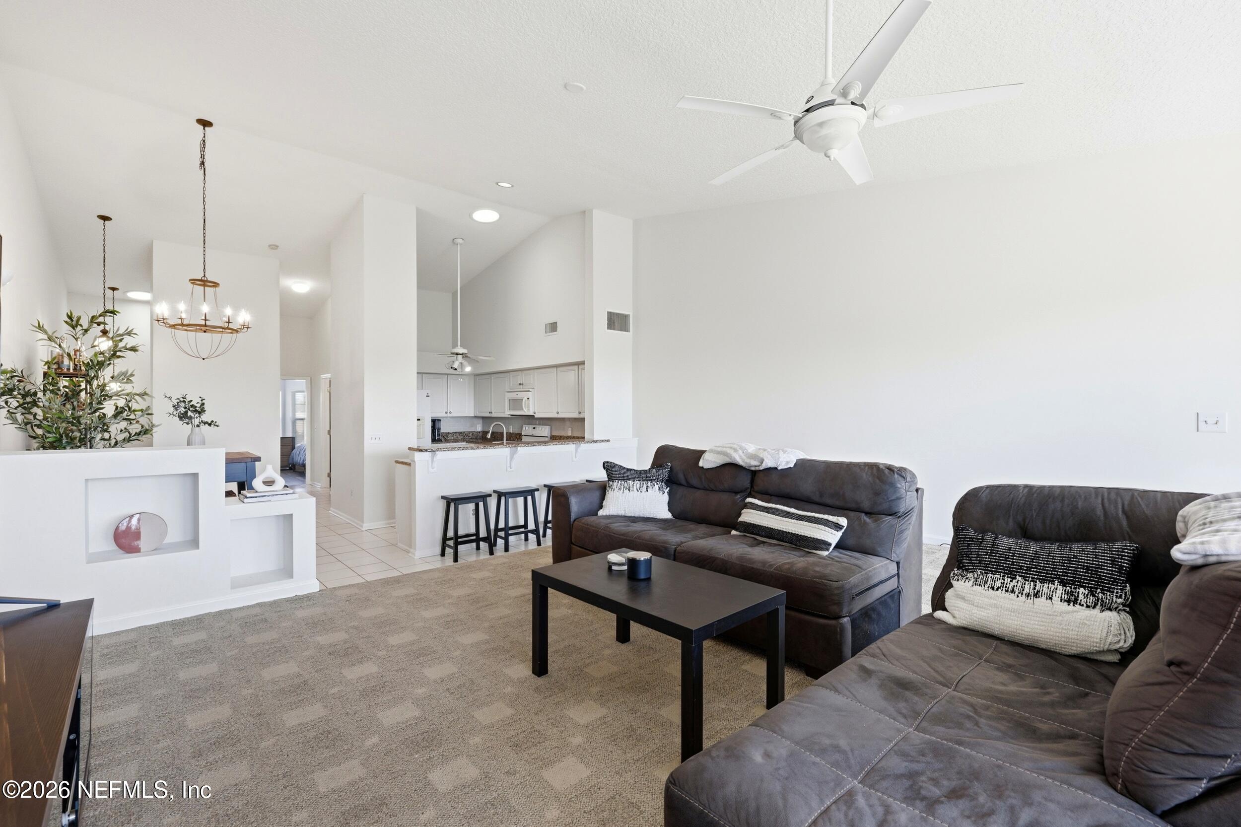 3331 Lighthouse Point Lane Jacksonville, FL 32250 - Photo 11 of 63 a living room with furniture and a chandelier