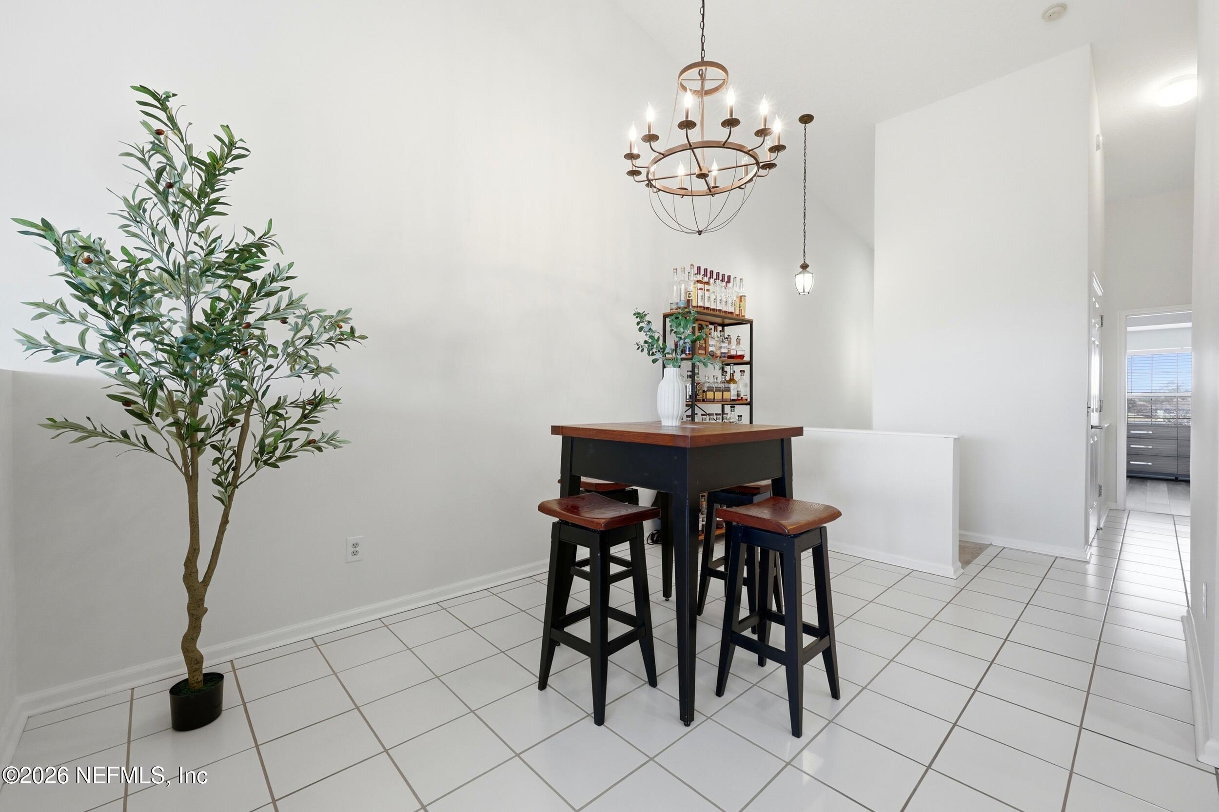 3331 Lighthouse Point Lane Jacksonville, FL 32250 - Photo 20 of 63 a view of a dining room with furniture and chandelier