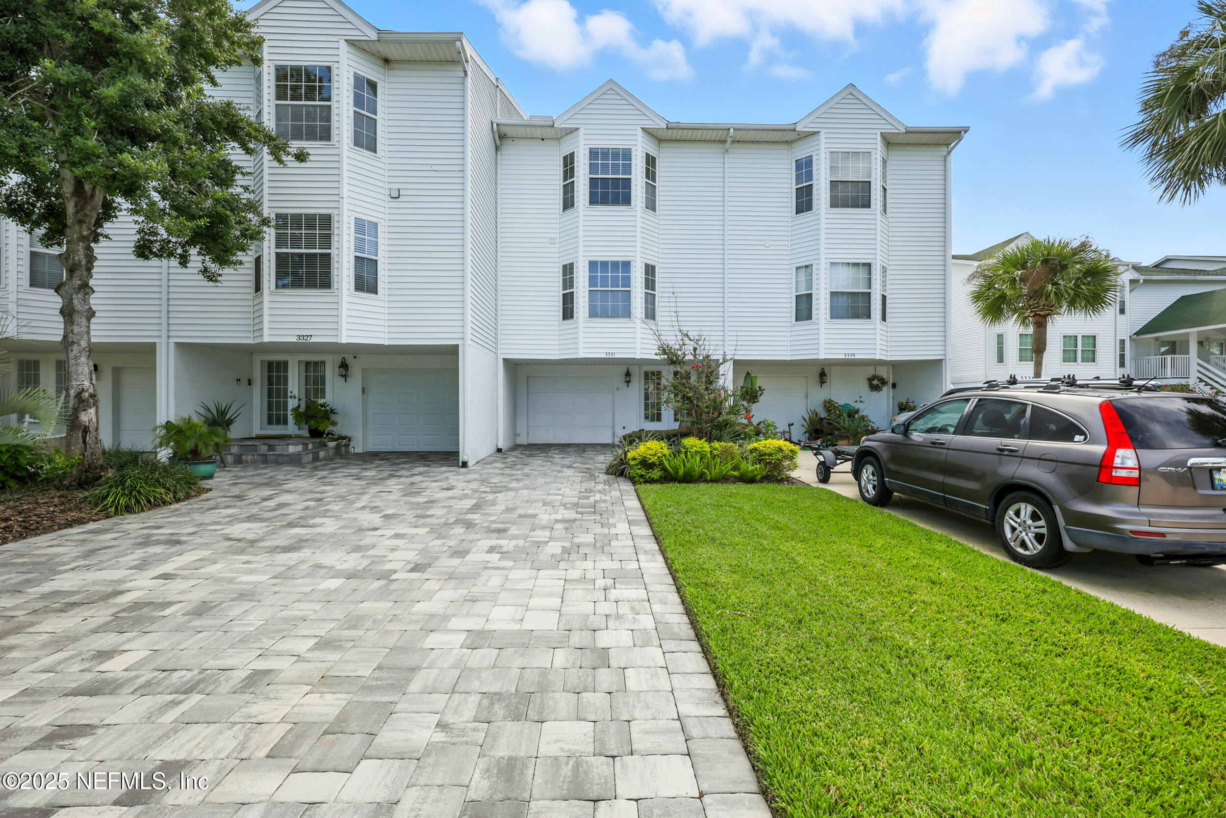 3331 Lighthouse Point Lane Jacksonville, FL 32250 - Photo 2 of 63 a view of a white house with a yard and sitting area