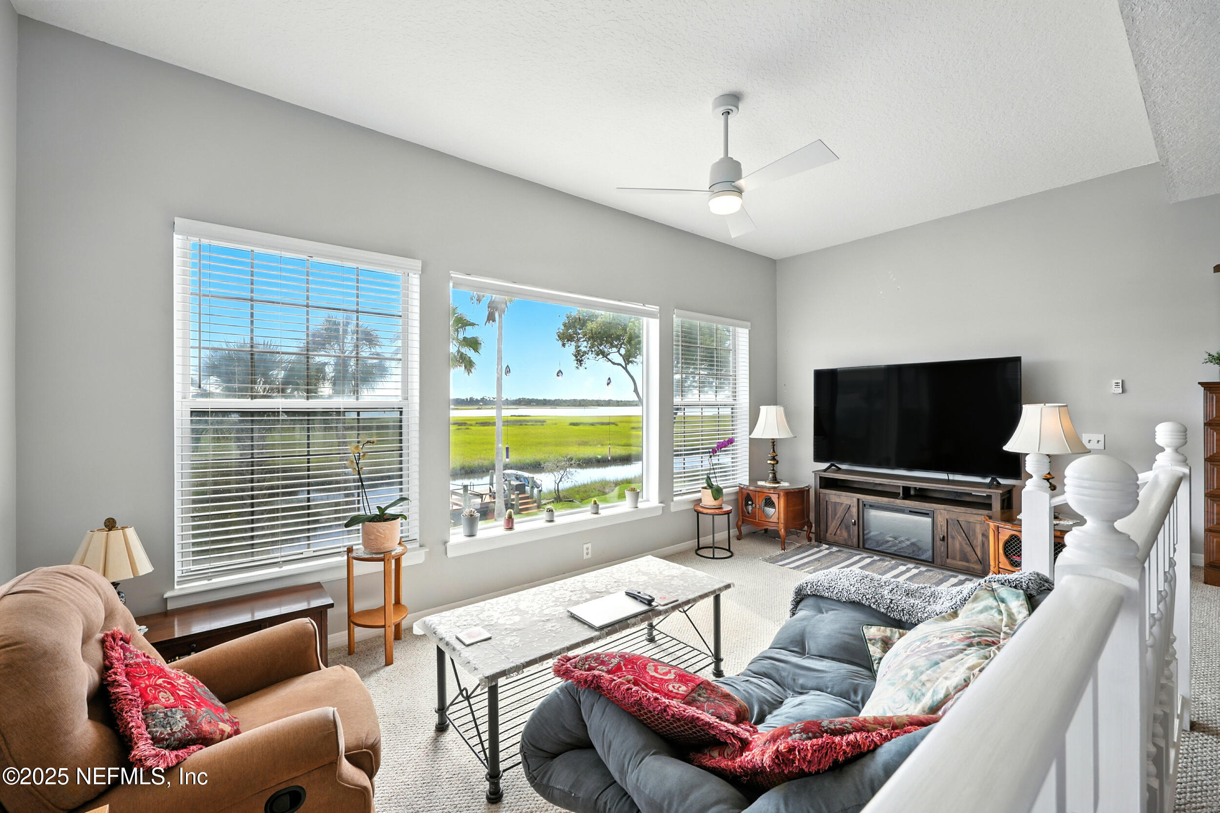 3331 Lighthouse Point Lane Jacksonville, FL 32250 - Photo 25 of 63 a living room with furniture and a flat screen tv