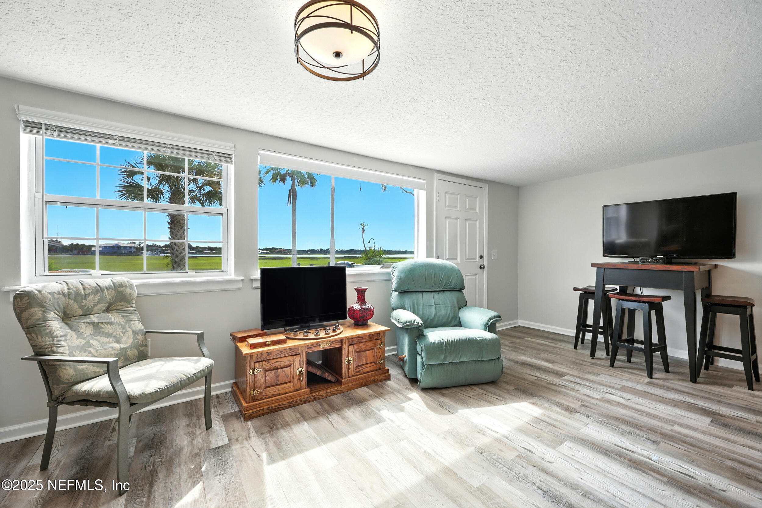 3331 Lighthouse Point Lane Jacksonville, FL 32250 - Photo 29 of 63 a living room with furniture and a flat screen tv