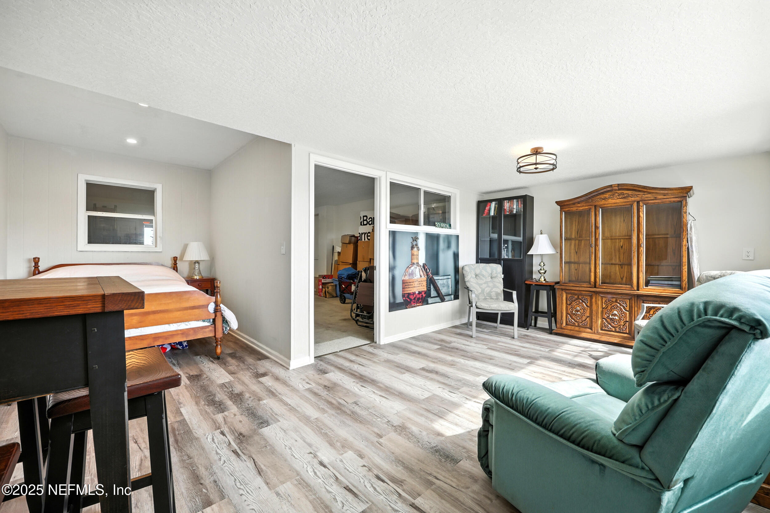 3331 Lighthouse Point Lane Jacksonville, FL 32250 - Photo 30 of 63 a living room with furniture and a flat screen tv