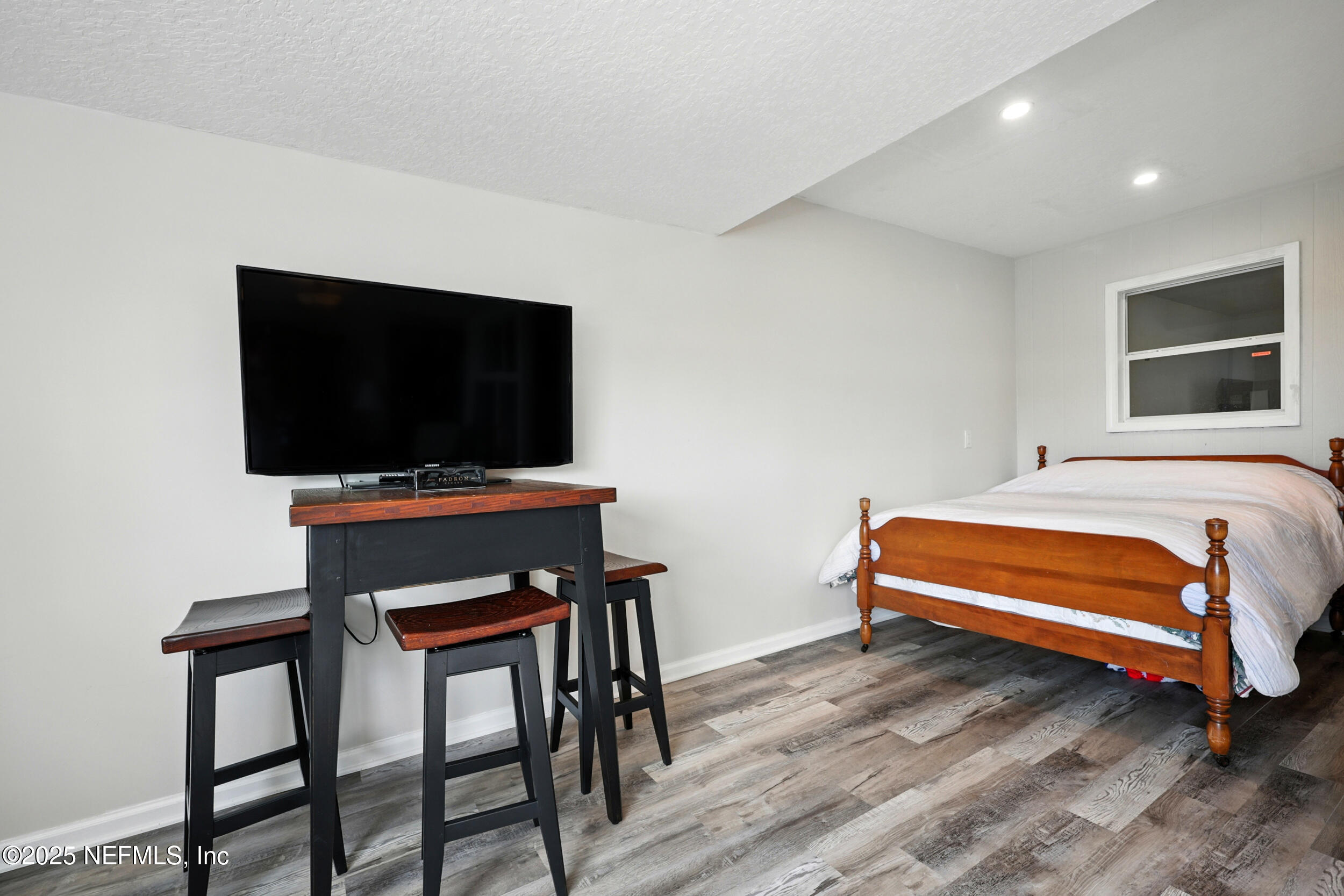 3331 Lighthouse Point Lane Jacksonville, FL 32250 - Photo 31 of 63 a bedroom with a bed and a flat screen tv