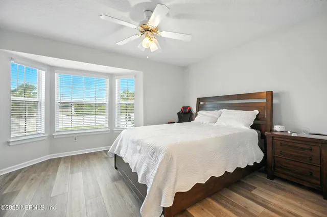 a large bed sitting in a bedroom next to a window