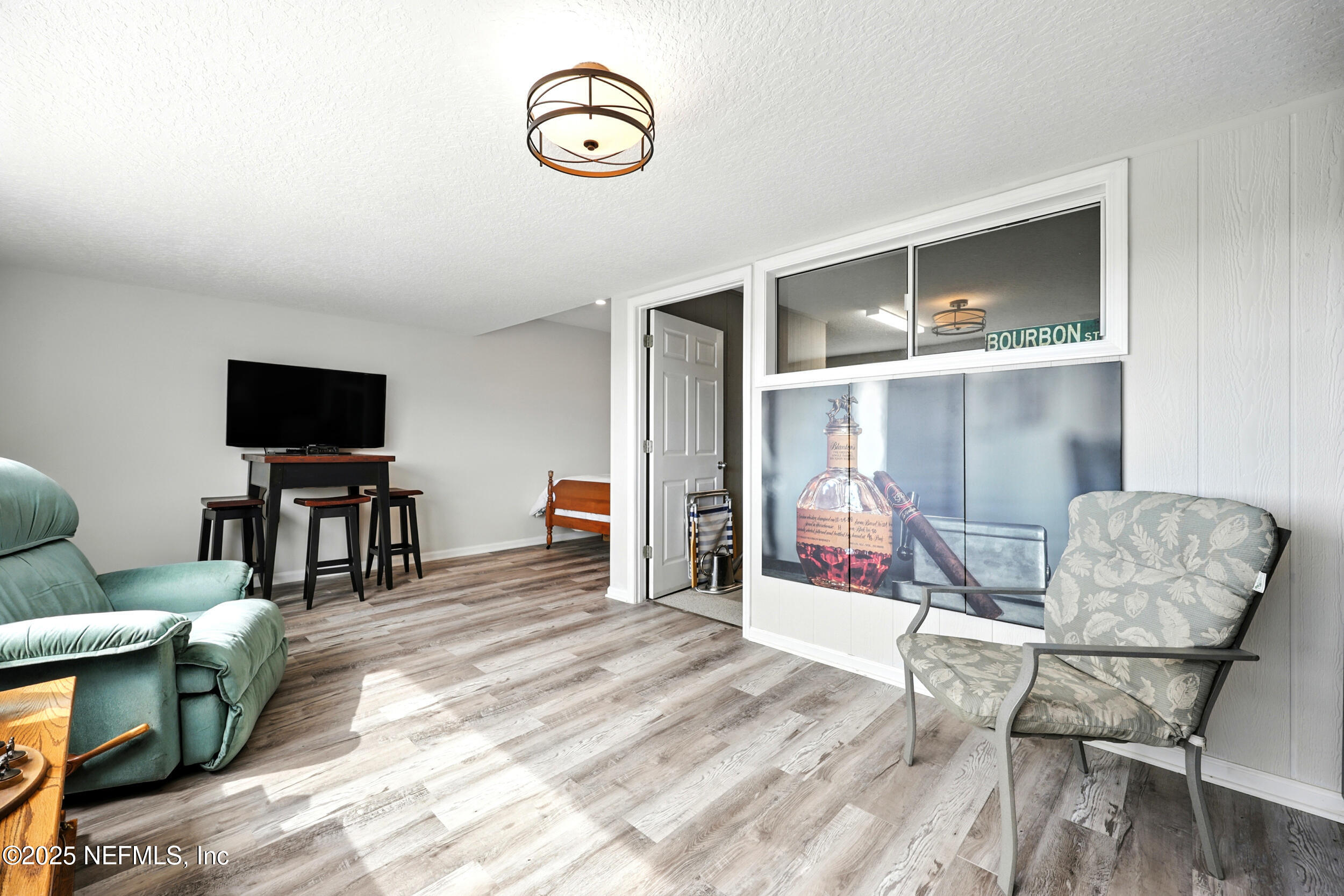 3331 Lighthouse Point Lane Jacksonville, FL 32250 - Photo 32 of 63 a living room with furniture and a flat screen tv