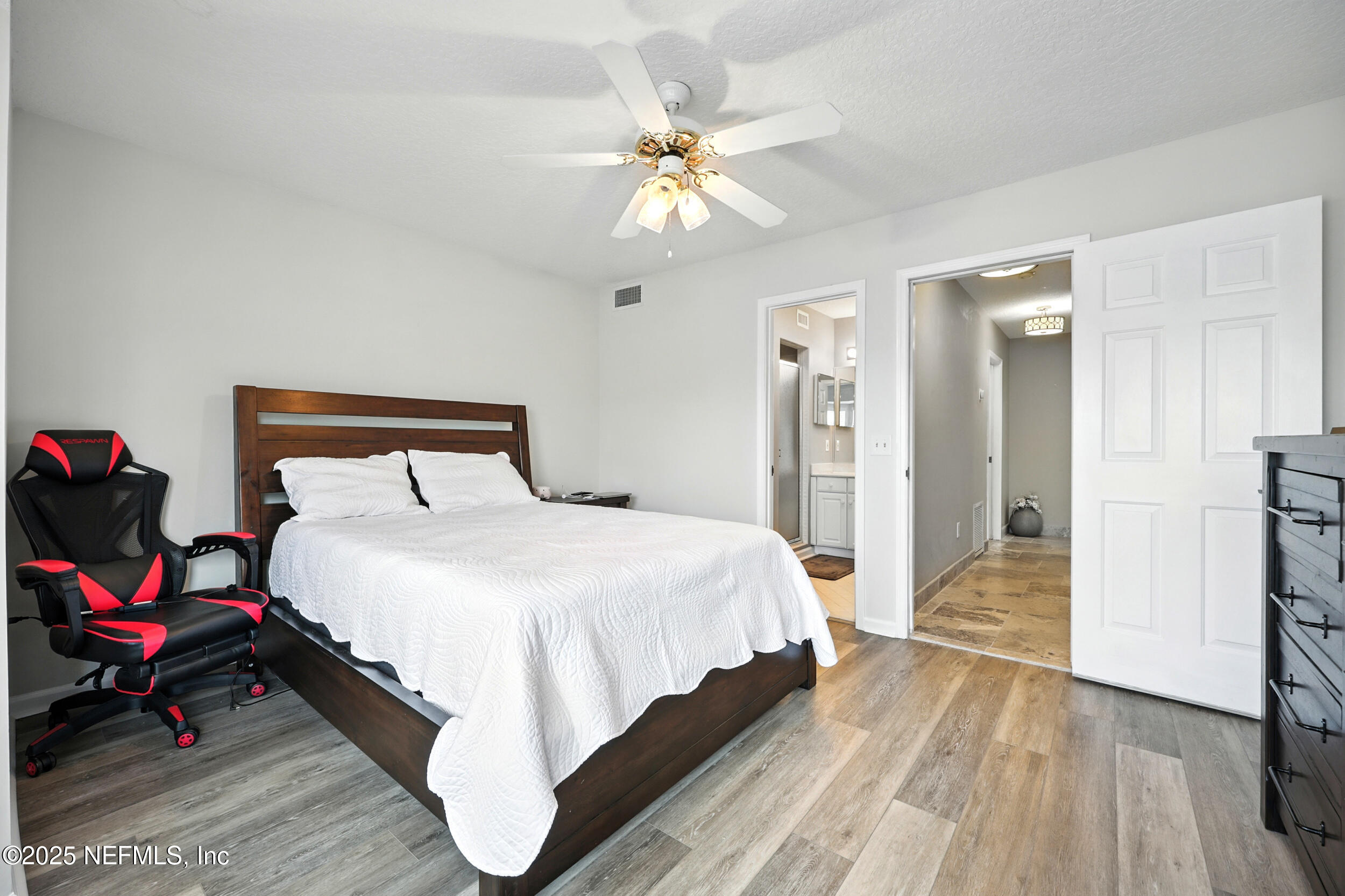 3331 Lighthouse Point Lane Jacksonville, FL 32250 - Photo 37 of 63 a bedroom with a bed and a chandelier