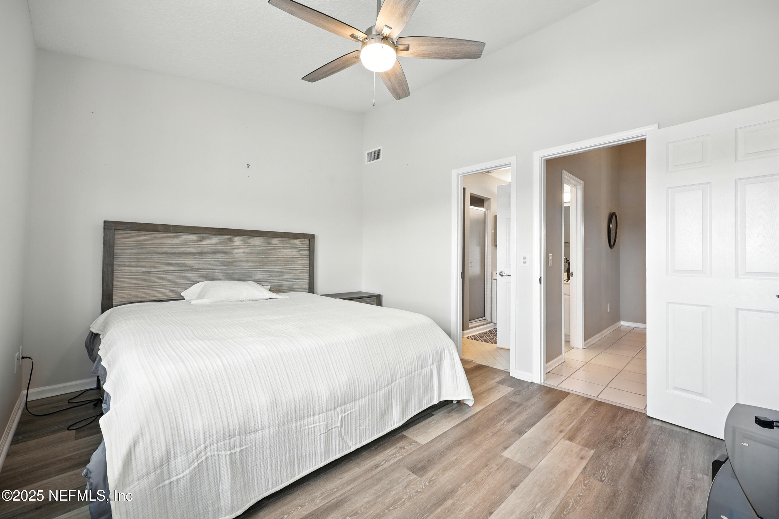 3331 Lighthouse Point Lane Jacksonville, FL 32250 - Photo 41 of 63 a bedroom with a bed and a chandelier