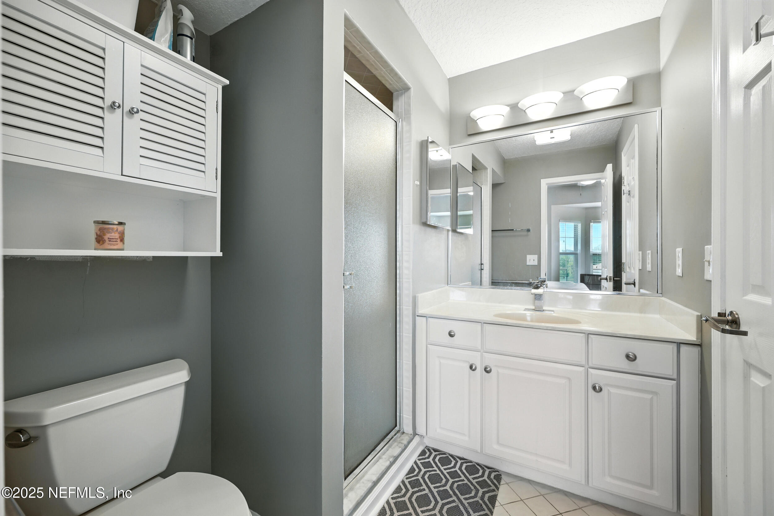 3331 Lighthouse Point Lane Jacksonville, FL 32250 - Photo 42 of 63 a bathroom with a toilet sink and mirror