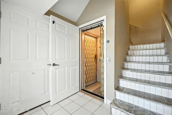 a view of a hallway with wooden shelves