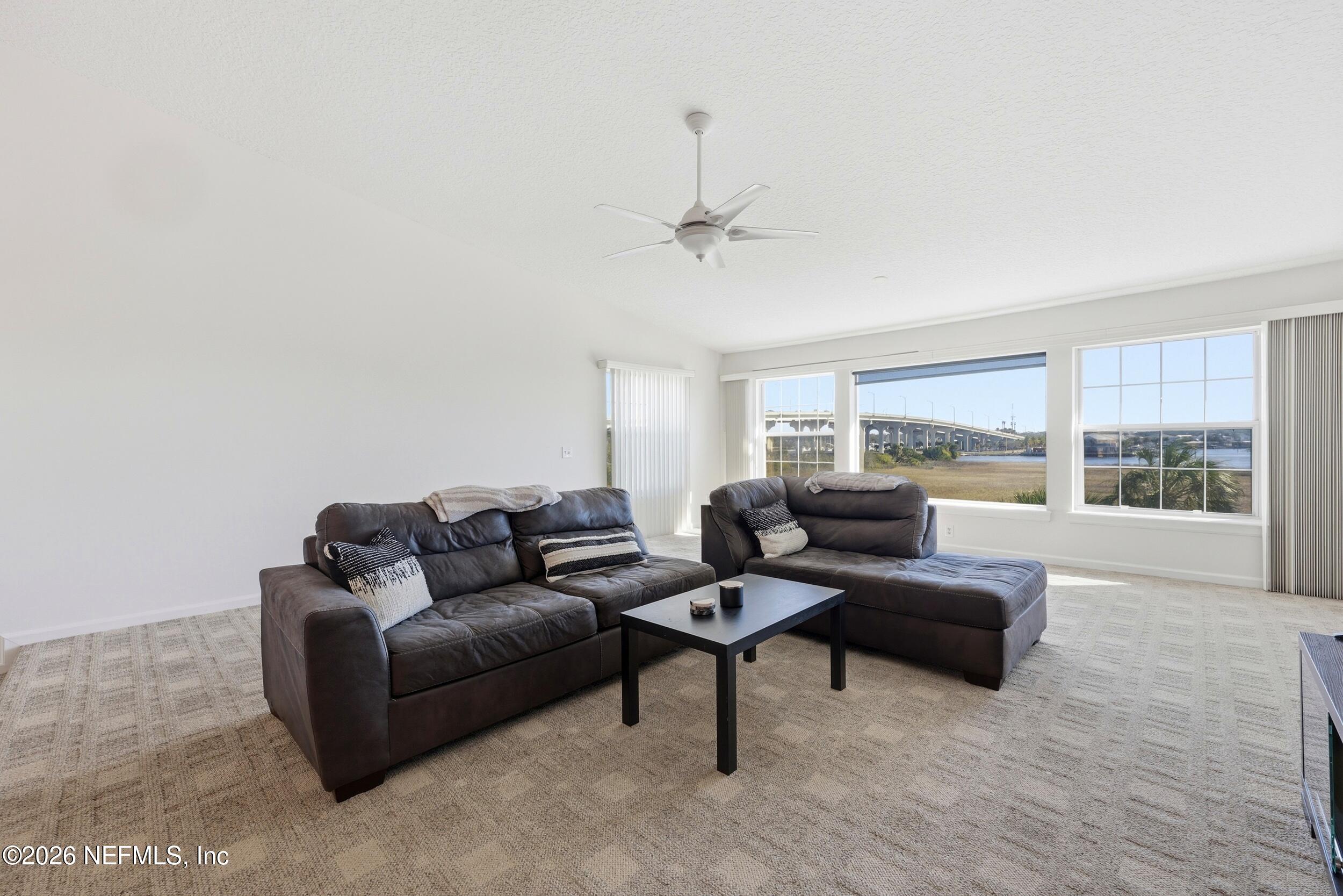 3331 Lighthouse Point Lane Jacksonville, FL 32250 - Photo 7 of 63 a living room with furniture and a large window