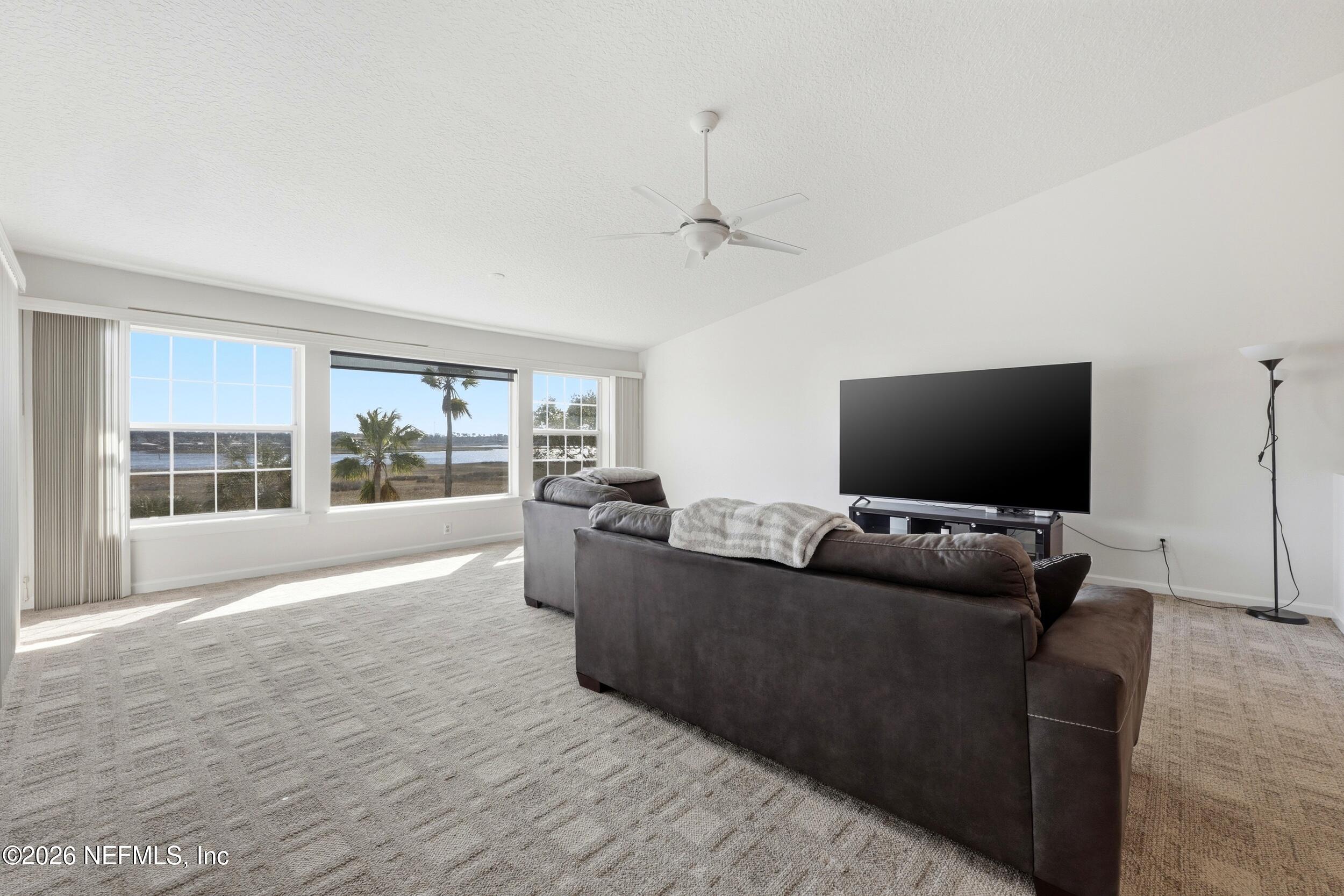 3331 Lighthouse Point Lane Jacksonville, FL 32250 - Photo 8 of 63 a living room with furniture and a flat screen tv