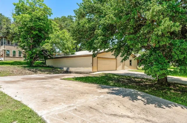 a front view of a house with a yard and a garage