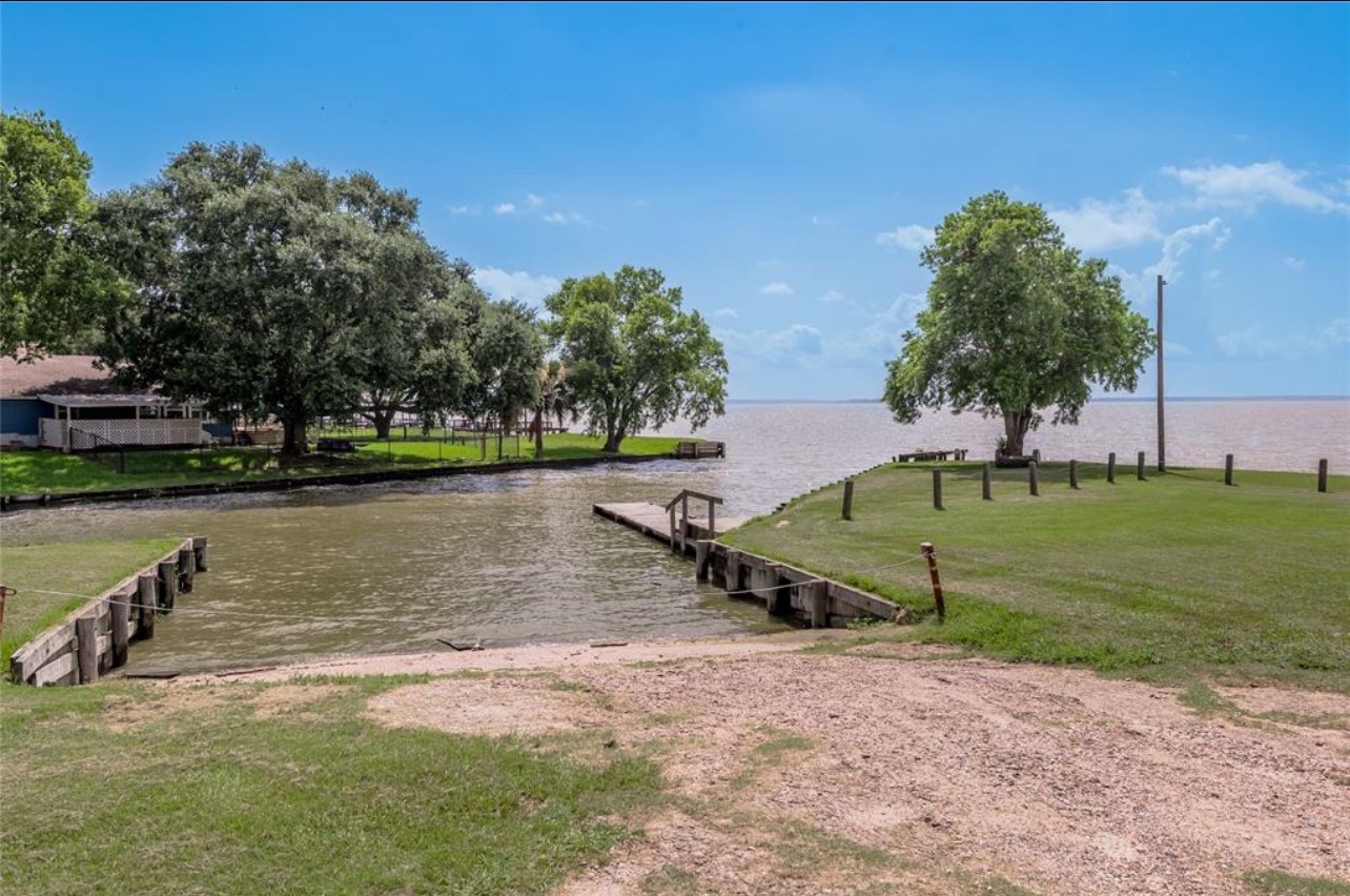 121 Lakeview Drive Point Blank, TX 77364 - Photo 7 of 10 a view of a lake with a yard