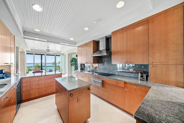 a bedroom with a bed a chandelier and a large window