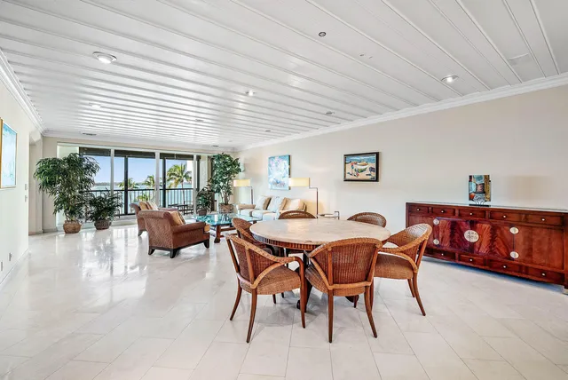 a dining room with furniture and a large window