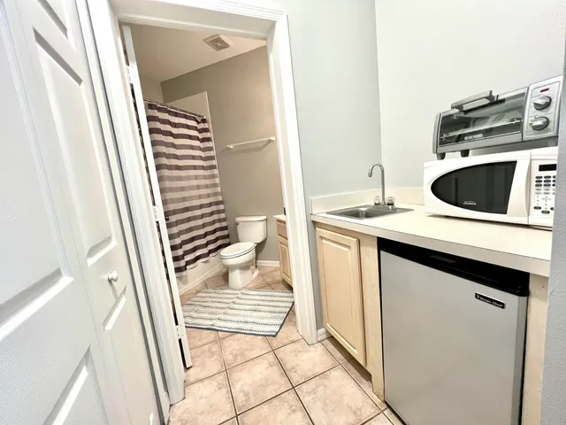 a kitchen with a sink and a washer dryer