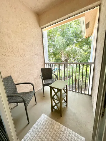 a view of a chair and table in the balcony