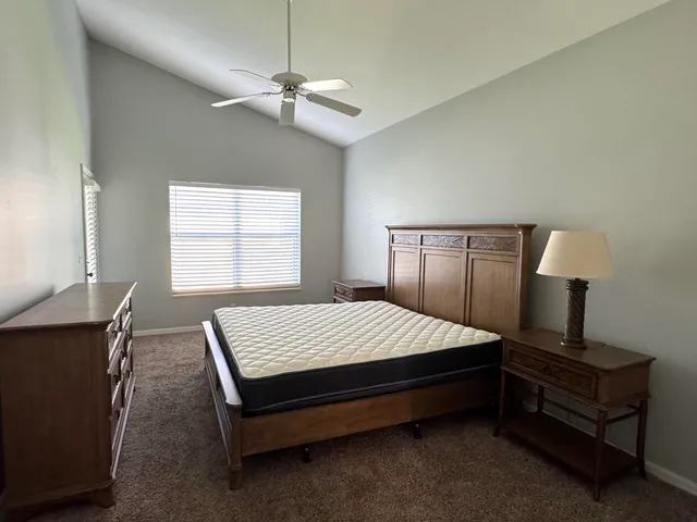 a bed sitting in a bedroom next to a window