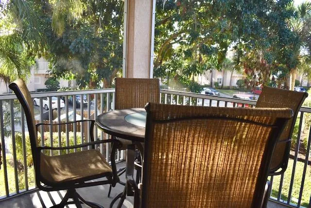 a view of a chairs and table in the balcony