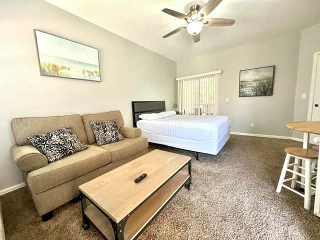 a bedroom with a bed and a couch