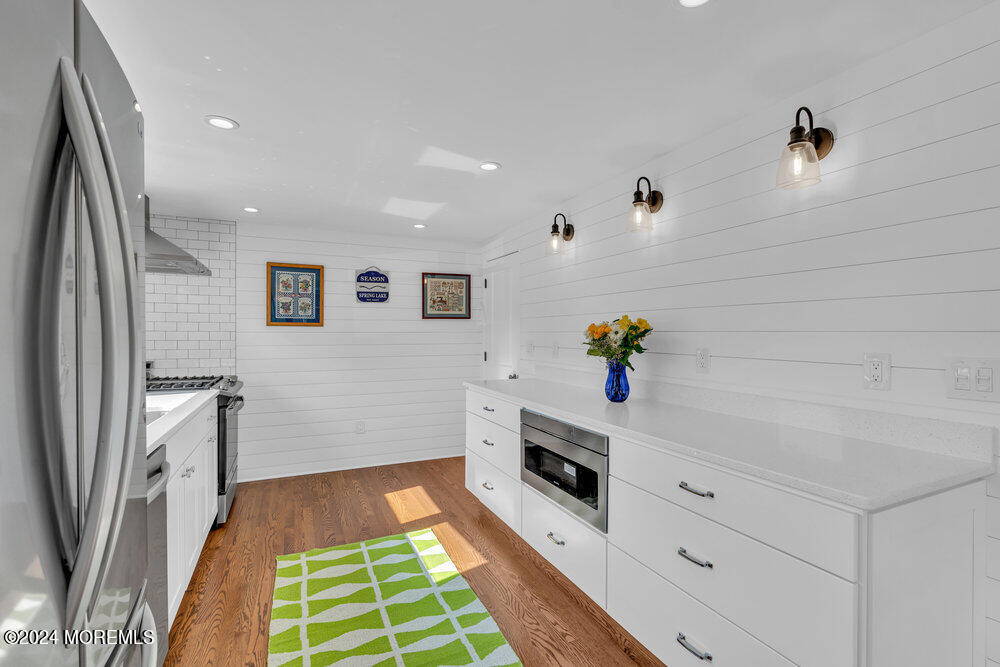2117 Murray Road Point Pleasant, NJ 08742 - Photo 11 of 35 a hallway with cabinets and wooden floor