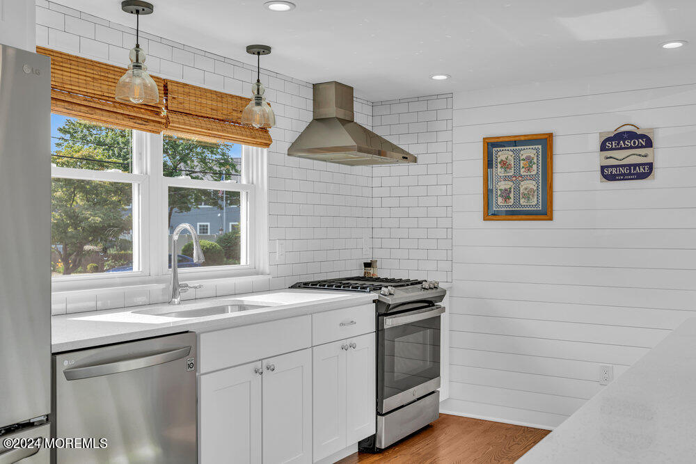 2117 Murray Road Point Pleasant, NJ 08742 - Photo 7 of 35 a kitchen with stainless steel appliances granite countertop a sink a stove a window and cabinets