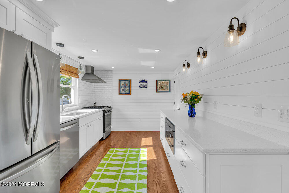 2117 Murray Road Point Pleasant, NJ 08742 - Photo 9 of 35 a kitchen with white cabinets and stainless steel appliances