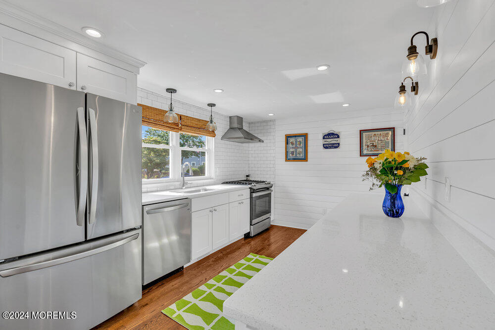 2117 Murray Road Point Pleasant, NJ 08742 - Photo 10 of 35 a kitchen with stainless steel appliances kitchen island granite countertop refrigerator and stove