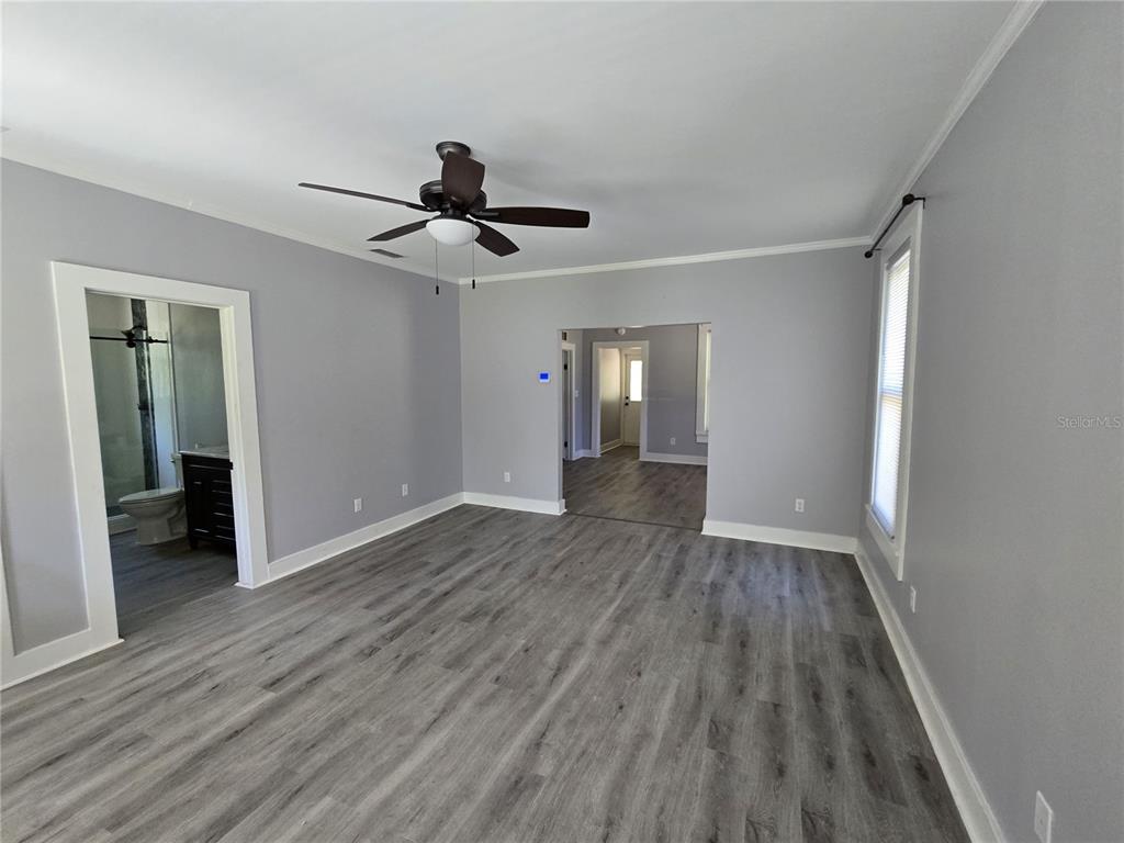 326 Southeast 2nd Street Williston, FL 32696 - Photo 14 of 30 wooden floor in an empty room with a window