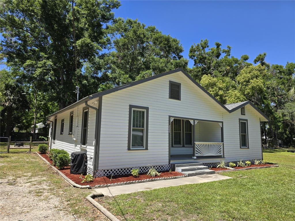 326 Southeast 2nd Street Williston, FL 32696 - Photo 2 of 30 a front view of house with yard outdoor seating and barbeque oven