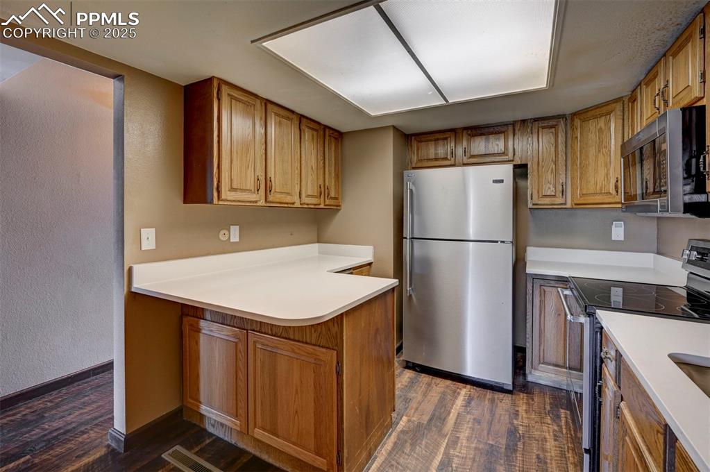 910 Fontmore Road, Unit B Colorado Springs, CO 80904 - Photo 11 of 32 a kitchen with a refrigerator sink and cabinets