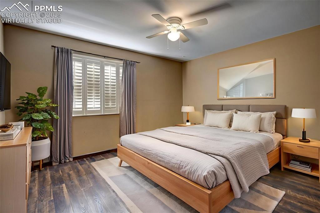 910 Fontmore Road, Unit B Colorado Springs, CO 80904 - Photo 17 of 32 a bedroom with a large bed and a chandelier